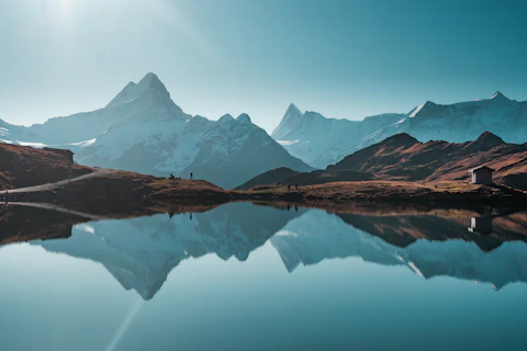 A mountain range with a lake in the foreground
